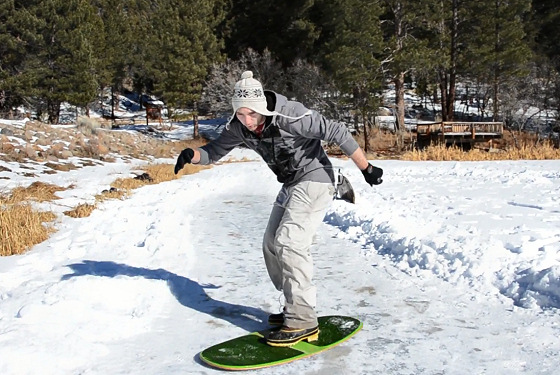 Ice skimboarding: sliding over the speed strip