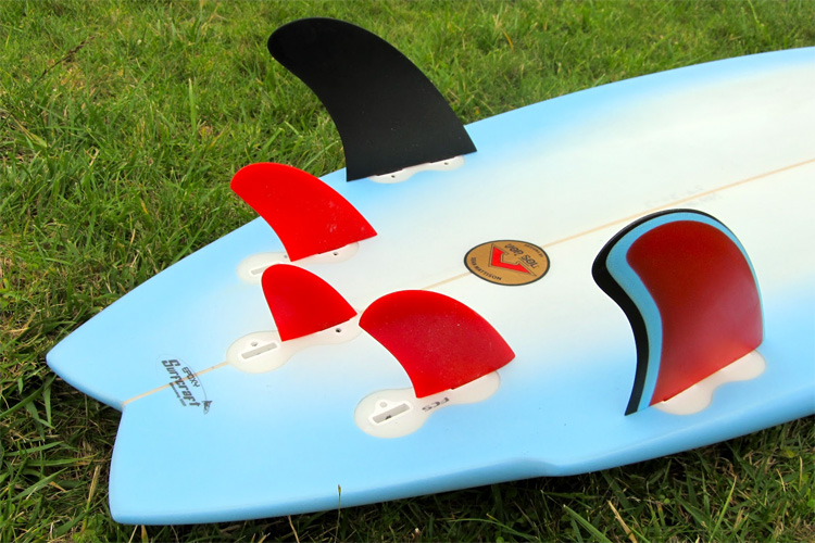 The Five-Fin Setup: four side fins and a small centered fin attached to the surfboard