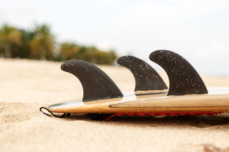 The Thruster Setup: two side fins and a center fin attached to the surfboard