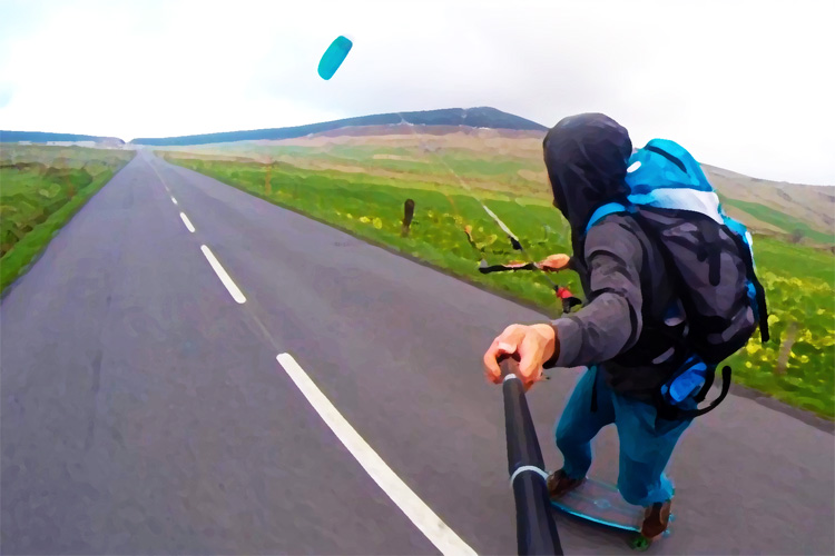 Didier Botta: skateboarding with a kite down the road