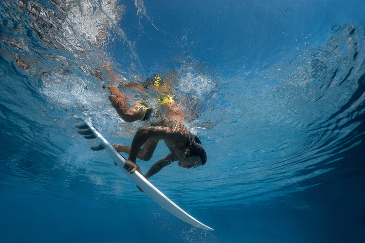 Duck diving: keep the board in a straight line while pushing it through the wave | Photo: Shutterstock