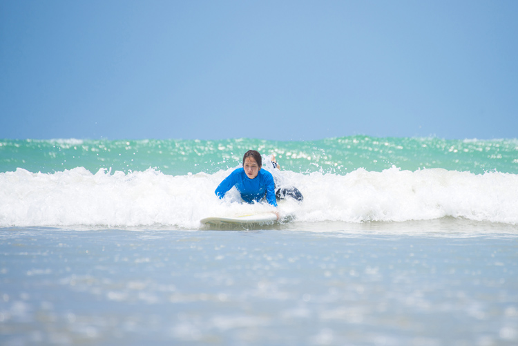 Catching waves: beginners surfers must paddle for a wave as soon as possible | Photo: Shutterstock