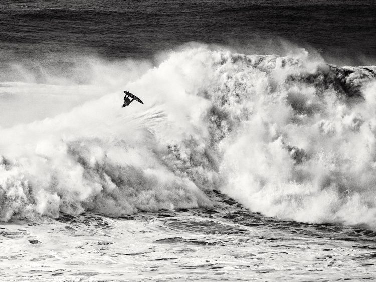 Kai Lenny: getting airborne on a massive Nazaré wave | Photo: Christian Stadler/Red Bull