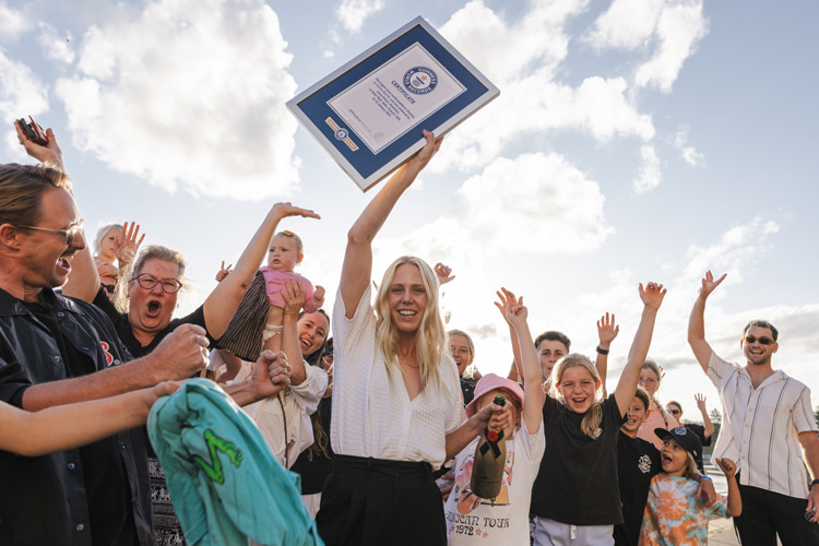Laura Enever: holding the Guinness World Record certificate surrounded by family and friends | Photo: WSL