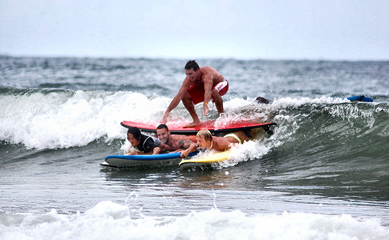 Surfing razzmatazz: crossed-surfboard surfing