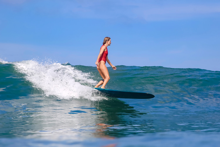 Women surfing: swimsuits can be a comfortable option in warm water lineups | Photo: Shutterstock